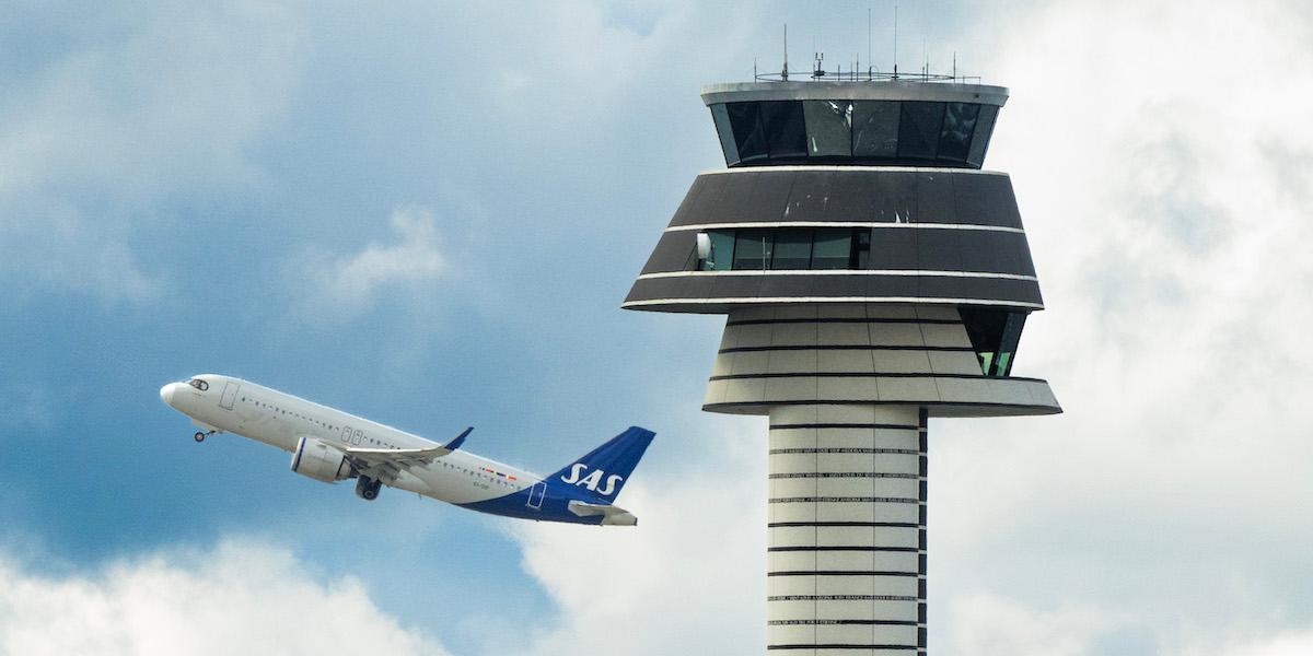 Ett flygplan flyger förbi flygtornet på Arlanda. När flygskatten sänks nästa år kommer inte flygbiljetterna bli billigare